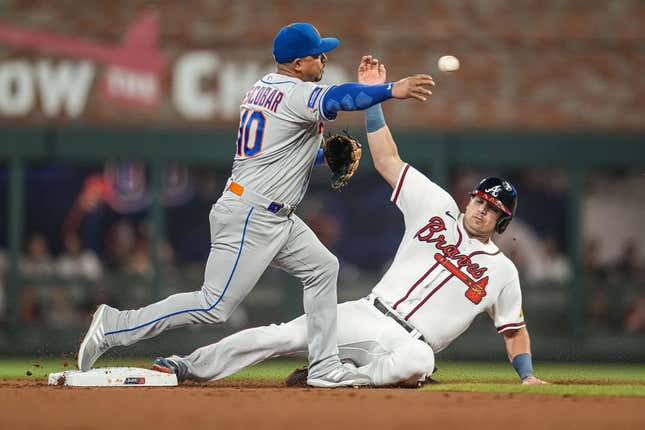 Jun 6, 2023; Cumberland, Georgia, USA; New York Mets third baseman Eduardo Escobar (10) throws for a double play over Atlanta Braves third baseman Austin Riley (27) during the first inning at Truist Park.