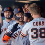 Jun 8, 2023; Denver, Colorado, USA; San Francisco Giants right fielder Michael Conforto (8) celebrates in the dugout on a two run home run in the sixth inning against the Colorado Rockies at Coors Field.