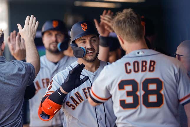 Jun 8, 2023; Denver, Colorado, USA; San Francisco Giants right fielder Michael Conforto (8) celebrates in the dugout on a two run home run in the sixth inning against the Colorado Rockies at Coors Field.