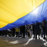 Russia muzzles public displays of blue and yellow, arrests those showing support for Ukraine