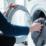 Person loads a tumble dryer