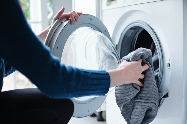 Person loads a tumble dryer