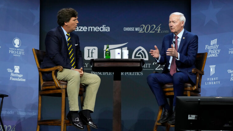 Asa Hutchinson clashes with Tucker Carlson on vaccination status