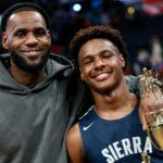 LeBron James, left, poses with his son Bronny after Sierra Canyon beat Akron St. Vincent - St. Mary in a high school basketball game Saturday, Dec. 14, 2019, in Columbus, Ohio. (AP Photo/Jay LaPrete)