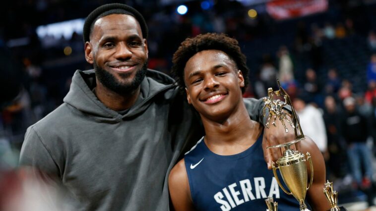 LeBron James, left, poses with his son Bronny after Sierra Canyon beat Akron St. Vincent - St. Mary in a high school basketball game Saturday, Dec. 14, 2019, in Columbus, Ohio. (AP Photo/Jay LaPrete)