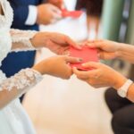 Elders giving red packet to newlywed couple