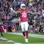 Arizona Cardinals wide receiver DeAndre Hopkins (10) celebrates after a touchdown catch against the Los Angeles Chargers during the first quarter at State Farm Stadium in Glendale on Nov. 27, 2022.