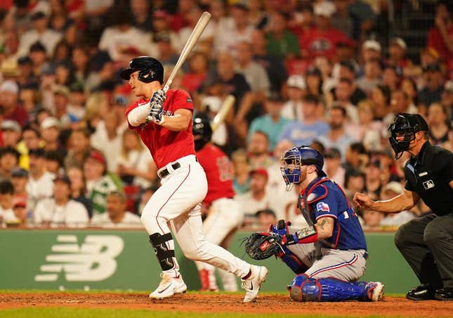 Jul 6, 2023; Boston, Massachusetts, USA; Boston Red Sox left fielder Rob Refsnyder (30) hits a single to center field to drive in a run against the Texas Rangers in the sixth inning at Fenway Park.