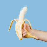 Hidden censored banana in hand on a blue background.