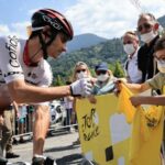 Cofidis rider Guillaume Martin signs a shirt for a young fan ahead of today’s stage.