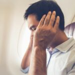 Male passenger having ear pop on the airplane