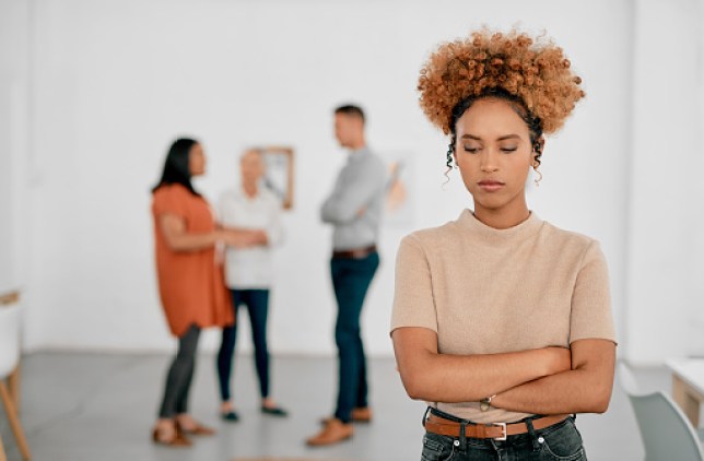 A woman being ostracised from her colleagues