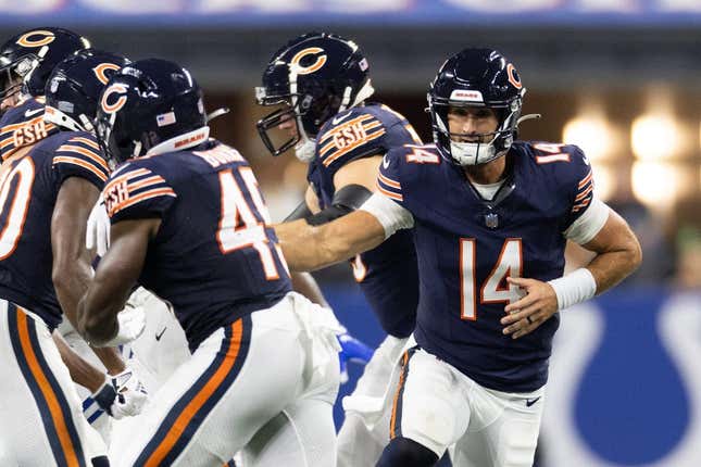 Aug 19, 2023; Indianapolis, Indiana, USA; Chicago Bears quarterback Nathan Peterman (14) hands off the ball to Chicago Bears fullback Robert Burns (45) in the second half against the Indianapolis Colts at Lucas Oil Stadium.