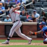 Aug 12, 2023; New York City, New York, USA; Atlanta Braves third baseman Austin Riley (27) follows through on an RBI single against the New York Mets during the first inning at Citi Field.