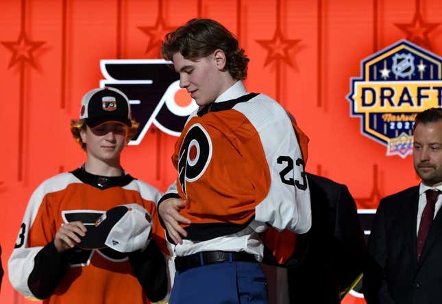 Jun 28, 2023; Nashville, Tennessee, USA; Philadelphia Flyers draft pick Oliver Bonk puts on his sweater after being selected with the twenty second pick in round one of the 2023 NHL Draft at Bridgestone Arena.