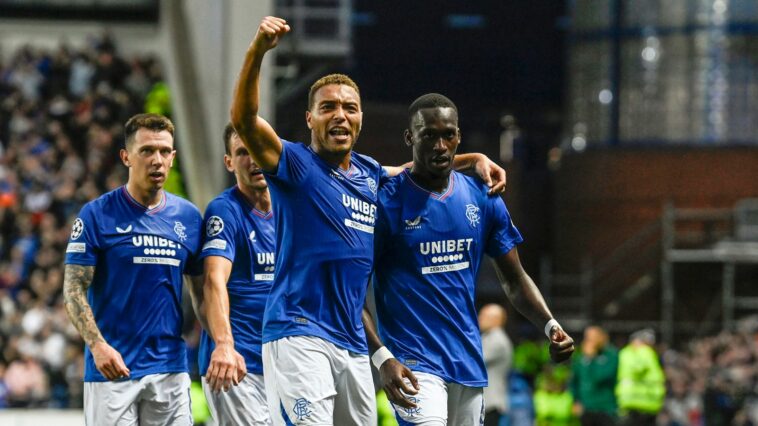 GLASGOW, SCOTLAND - AUGUST 22: Rangers' Abdallah Sima (R) celebrates with Cyriel Dessers after scoring to make it 1-0 during a UEFA Champions League play-off round first leg match between Rangers and PSV Eindhoven at Ibrox Stadium, August 22, 2023, in Glasgow, Scotland. (Photo by Rob Casey / SNS Group)