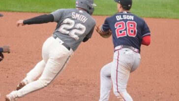 WASHINGTON, DC - SEPTEMBER 24: Matt Olson #28 of the Atlanta Braves tags out Dominic Smith #22 of the Washington Nationals trying to steal a base in the fifth inning during game one of a doubleheader at Nationals Park on September 24, 2023 in Washington, DC. (Photo by Mitchell Layton/Getty Images)