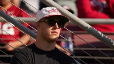 STANFORD, CALIFORNIA - SEPTEMBER 23: Christian McCaffrey of the San Francisco 49ers watches the game between the Arizona Wildcats and Stanford Cardinal at Stanford Stadium on September 23, 2023 in Stanford, California. (Photo by Loren Elliott/Getty Images)