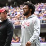 Aug 26, 2023; Minneapolis, Minnesota, USA; Arizona Cardinals quarterback Kyler Murray (right) walks onto the field at  U.S. Bank Stadium before the game between the Minnesota Vikings and the Arizona Cardinals.