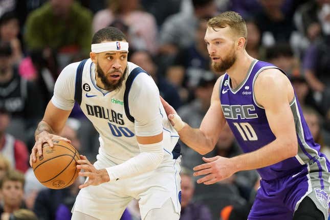 Feb 11, 2023; Sacramento, California, USA; Dallas Mavericks center JaVale McGee (00) handles the ball against Sacramento Kings forward Domantas Sabonis (10) during the third quarter at Golden 1 Center.