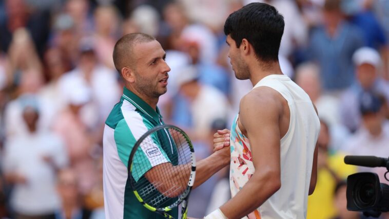 Dan Evans (L) of Great Britain shakes hands with Carlos Alcaraz of Spain after being defeated in their Men's Singles Third Round match on Day Six of the 2023 US Open at the USTA Billie Jean King National Tennis Center on September 02, 2023 in the Flushing neighborhood of the Queens borough of New York City. (Photo by Clive Brunskill/Getty Images)