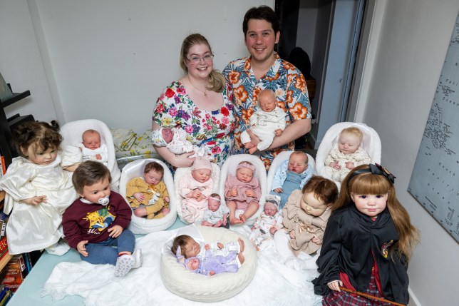 Jess Ellis with partner Avery Raassen with their collection of re born dolls