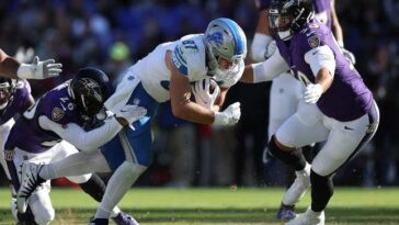 BALTIMORE, MARYLAND - OCTOBER 22: Sam LaPorta #87 of the Detroit Lions is tackled with the ball by Geno Stone #26 of the Baltimore Ravens in the second half of the game  at M&amp;T Bank Stadium on October 22, 2023 in Baltimore, Maryland. (Photo by Patrick Smith/Getty Images)