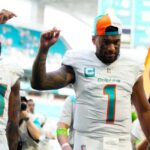 MIAMI GARDENS, FLORIDA - OCTOBER 15: Raheem Mostert #31 and Tua Tagovailoa #1 of the Miami Dolphins walk off the field after a win over the Carolina Panthers at Hard Rock Stadium on October 15, 2023 in Miami Gardens, Florida. (Photo by Rich Storry/Getty Images)