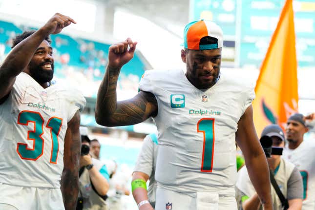 MIAMI GARDENS, FLORIDA - OCTOBER 15: Raheem Mostert #31 and Tua Tagovailoa #1 of the Miami Dolphins walk off the field after a win over the Carolina Panthers at Hard Rock Stadium on October 15, 2023 in Miami Gardens, Florida. (Photo by Rich Storry/Getty Images)