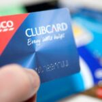 A Tesco Clubcard being held