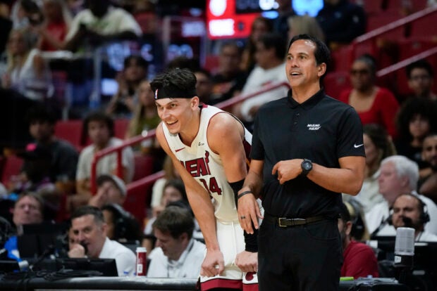 Miami Heat head coach Erik Spoelstra talks with guard Tyler Herro (14) during the second half of an NBA preseason basketball game, Sunday, Oct. 15, 2023, in Miami.