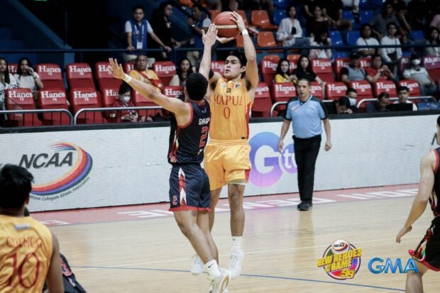 Mapua's Clint Escamis shoots over the Letran defense