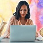 A woman working at a laptop with snails photoshopped around her