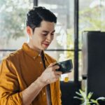 Handsome Young Man Drinking Hot Tea in the Morning