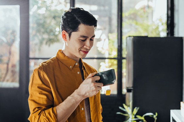 Handsome Young Man Drinking Hot Tea in the Morning