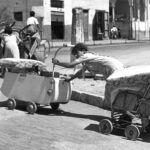 Barefoot and pushing their belongings in prams and carts, Arab families leave  the coastal town of Jaffa which became part of the greater Tel Aviv area in the state of Israel.