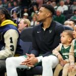 MILWAUKEE, WISCONSIN - DECEMBER 16: Giannis Antetokounmpo #34 of the Milwaukee Bucks sits on the bench with his children, Liam and Maverick, during a game against the Detroit Pistons at Fiserv Forum on December 16, 2023 in Milwaukee, Wisconsin. NOTE TO USER: User expressly acknowledges and agrees that, by downloading and or using this photograph, User is consenting to the terms and conditions of the Getty Images License Agreement. (Photo by Stacy Revere/Getty Images)