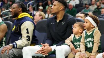 MILWAUKEE, WISCONSIN - DECEMBER 16: Giannis Antetokounmpo #34 of the Milwaukee Bucks sits on the bench with his children, Liam and Maverick, during a game against the Detroit Pistons at Fiserv Forum on December 16, 2023 in Milwaukee, Wisconsin. NOTE TO USER: User expressly acknowledges and agrees that, by downloading and or using this photograph, User is consenting to the terms and conditions of the Getty Images License Agreement. (Photo by Stacy Revere/Getty Images)