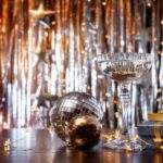 New Year celebration concept with golden lights and champagne flute