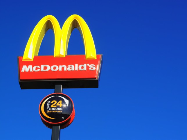 London, United Kingdom - June 2, 2011 : McDonald's yellow and red logo advertising sign placed on a pole with a clear blue sky with copy space