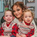 Mother Emily Wyatt with her two sons, Teddy (L) and Reginald (R) in their home on December 6 2023. See SWNS story SWTPseizure. A hero six-year-old saved his mum's life when she had a seizure - by following instructions she taught him using a song about ambulances. Teddy Wyatt called 999 after hearing shouting and weird noises coming from Emily Wyatt's bedroom. The 27-year-old mum has epilepsy and was suffering from a severe episode. Brave Teddy stayed on the phone while paramedics talked him through what to do - and even made sure his two-year-old brother's stairgate was shut so he was safe. Emily says her son knew to call the emergency services after she taught him the lyrics to the Ambulance Song when he was aged three. The educational tune describes how an ambulance can help in a challenging situation.