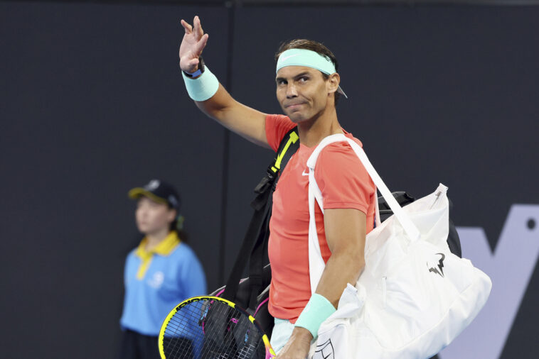 Rafael Nadal of Spain waves to the crowd in his doubles match against Australia's Max Purcell and Jordan Thompson during the Brisbane International tennis tournament in Brisbane, Australia, Sunday, Dec. 31, 2023.