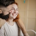 Portrait of a happy couple at home in bed