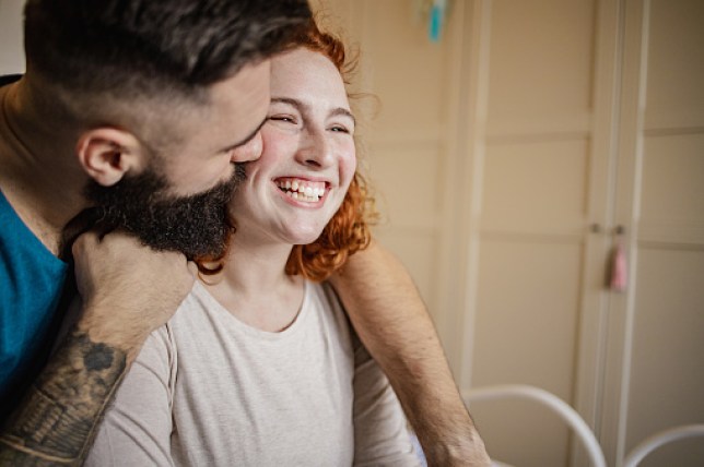 Portrait of a happy couple at home in bed