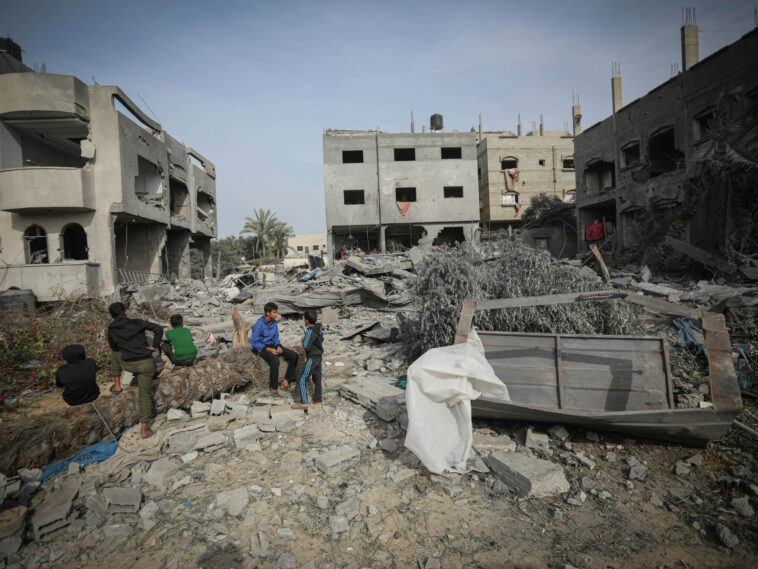 ‘A hand here, a head there’: Israeli warplanes kill dozens in central Gaza