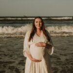 Ruth Barrett cradling pregnancy baby bump