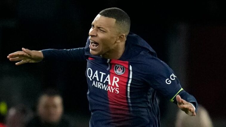 PSG's Kylian Mbappe celebrates after scoring his side's first goal from the penalty spot during the Champions League group F soccer match between Paris Saint-Germain and Newcastle United FC at the Parc des Princes in Paris, Tuesday, Nov. 28, 2023. (AP Photo/Christophe Ena)