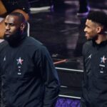 Pro-basketball players LeBron James (L) and Giannis Antetokounmpo (R) stand on stage during the mock draft ahead of the All-Star game between Team Giannis and Team LeBron at the Vivint arena in Salt Lake City, Utah, February 19, 2023.