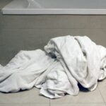 Dirty towels on bathroom floor