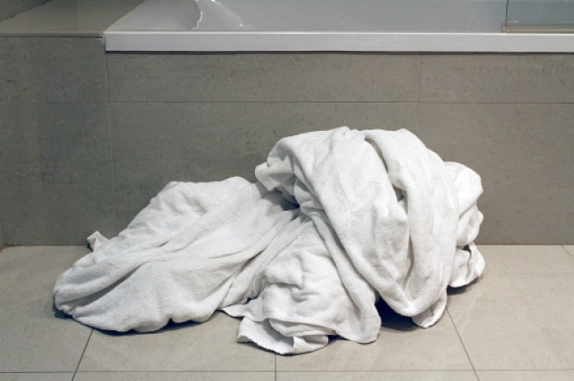 Dirty towels on bathroom floor